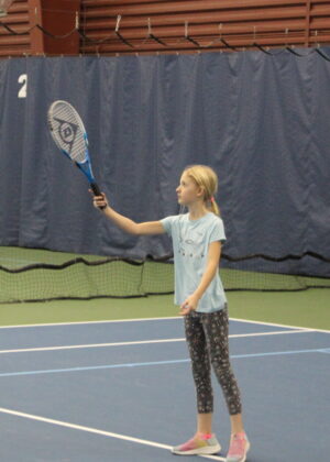 photo of a girl holding a tennis racket