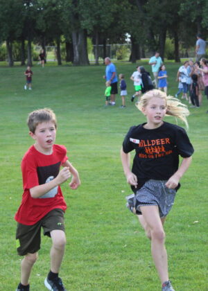 photo of a boy and girl running