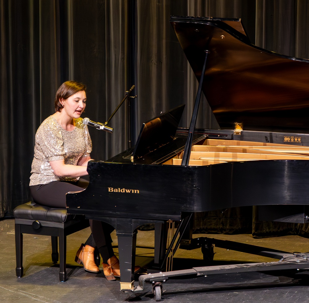 photo of a woman playing piano and singing