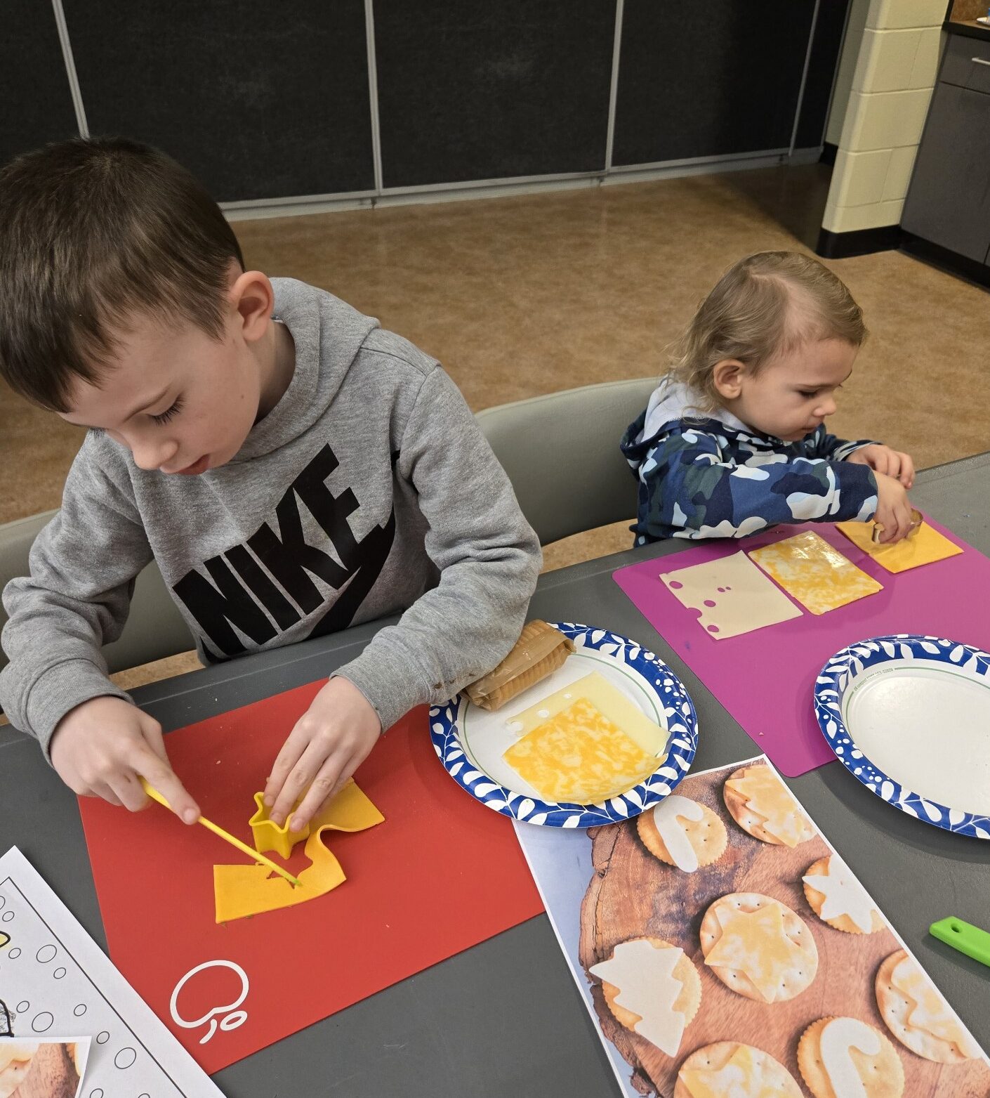 photo of two children preparing food in the Little Cooks class.