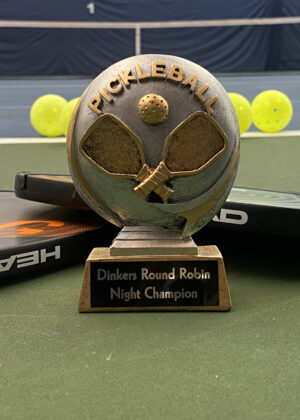 photo of a trophy with two pickleball paddles